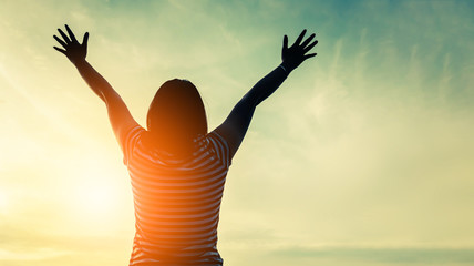 happiness and jouful woman girl rise hand up into sky background