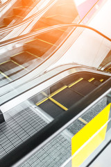 Close up to escalator yellow and gray steel line.