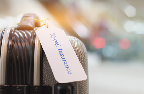Travel Insurance tag on suitcase holder with tag tied letters enjoyable your trip on bag. Travel Insurance is intended cover medical expenses, cover lost luggage, flight cancellation or accident.
