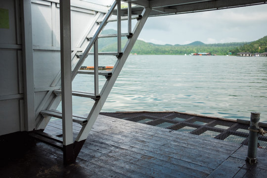 steel stair of boat with lake and mountain are background. this image for business, travel, transport, scenery, nature, seascape, landscape concept