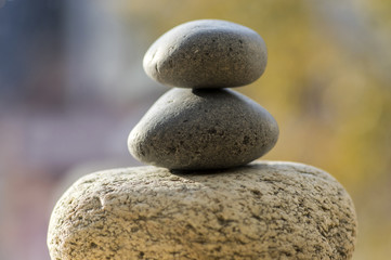 Fototapeta na wymiar Three zen stones pile, white and grey meditation pebbles tower