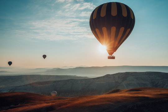 Hot air balloons flying over the valley at Cappadocia. Turkey