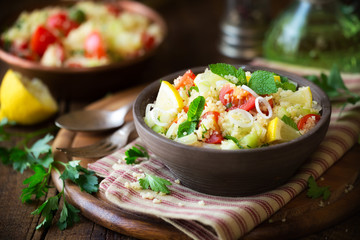 Vegetarian tabbouleh - delicious couscous salad with cherry tomatoes, cucumbers, fresh mint and...