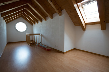 empty attic room in a beautiful apartment after completed renovations