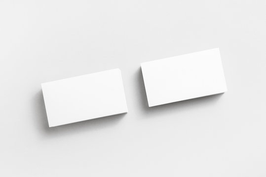 Blank business cards on paper background. Mockup for branding identity. Studio shot. Top view.