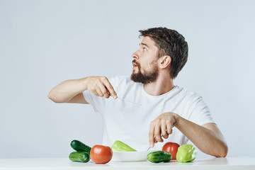 A man is wondering whether he can eat all these vegetables