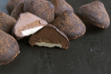 Chocolate truffles on a grey background.