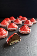candy in a red wrapper on a dark background.