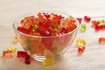 gummy bears on wooden background