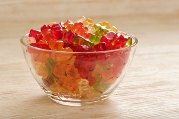 gummy bears on wooden background