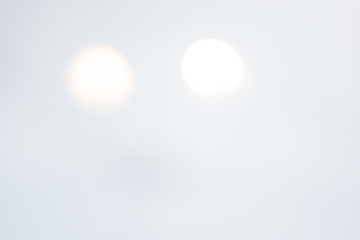 White, Light Background of Glass and Light Yellow Spots of Lights.