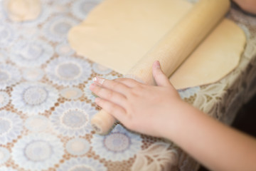 Obraz na płótnie Canvas Woman's hands roll the dough. Protection Symbol, heat comfort.