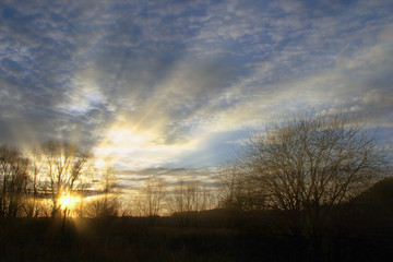 beautiful sky with clouds at sunset and the rays of the sun