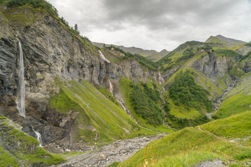 view of natural amphitheater with five waterfalls in the Weisstannen Valley in the Swiss Alps