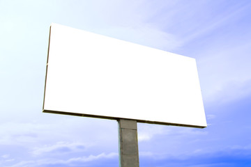 Obraz premium A large concrete billboard with a white screen against a blue sky on a sunny summer day.