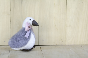 Goose Doll Tie Bow Pink on wooden floor.