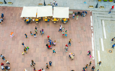 Aerial view of people walking through krakowskie przedmiescie street in Warsaw, Poland
