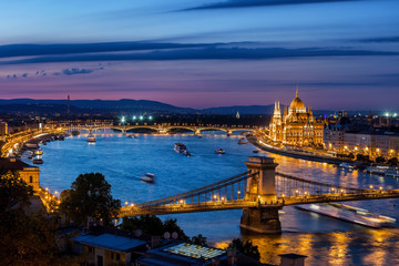 Naklejka na ściany i meble City of Budapest at dusk in Hungary, blue hour cityscape with lighted Chain Bridge and Hungarian Parliament at Danube River