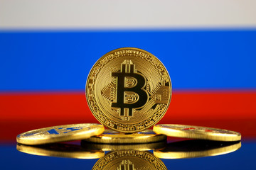 Physical version of Bitcoin (new virtual money) and Russia Flag. Conceptual image for investors in cryptocurrency and Blockchain Technology in Russia.