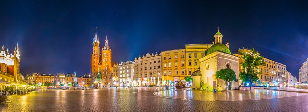Night view of the rynek glowny main square with the church of Saint Mary and church of Saint Adalbert in the polish city Cracow/Krakow.