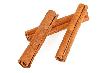 Three cinnamon sticks on a white background, top view