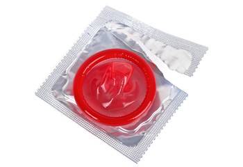 Red condom with open pack isolated on white background