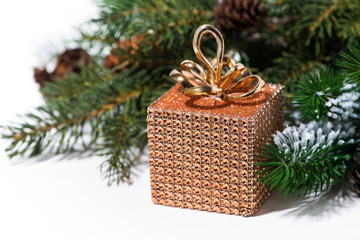 Naklejka na ściany i meble Christmas decoration golden box on a white background, closeup