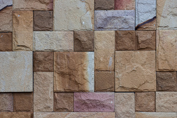 Sandstone wall is the background.