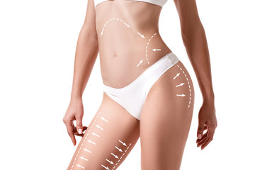Female body with the drawing arrows on it isolated on white. Fat lose, liposuction and cellulite removal concept. - obrazy, fototapety, plakaty