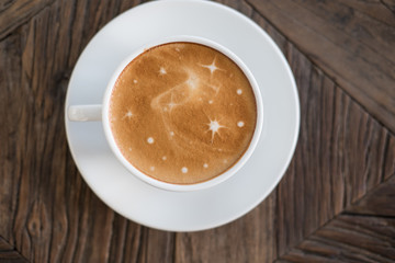 hot cappuccino coffee in white cup on wood table