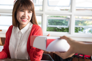 startup small business owner give parcel box to delivery man for sending to customer. woman's hand receive product from seller at shop.  Online selling, e-commerce, shipping concept