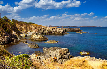Fototapeta na wymiar Coastal landscape - the rocky seashore with the village of Sozopolis, near city of Sozopol in Bulgaria