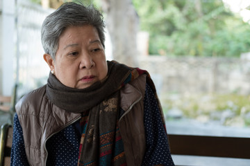 portrait of elder woman, elderly female, senior with bored expression.