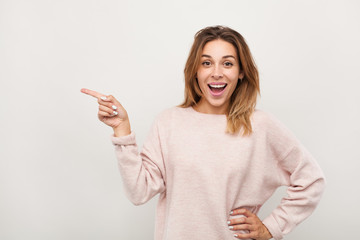 Excited woman pointing on side