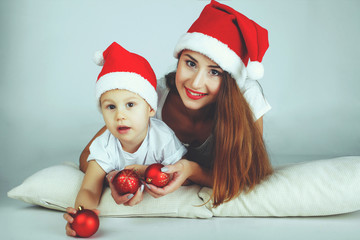 happy mother and baby in red Christmas hats