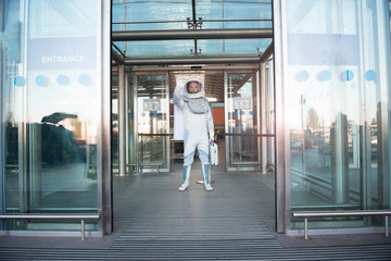 Fototapeta na wymiar Hope it is not dangerous. Confident astronaut ready for going out and looking ahead with seriousness. Full length portrait. Copy space on right side