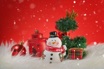 Happy snowman standing in winter christmas snow background. Merry christmas and happy new year greeting card with copy-space. Christmas celebration holiday background.
