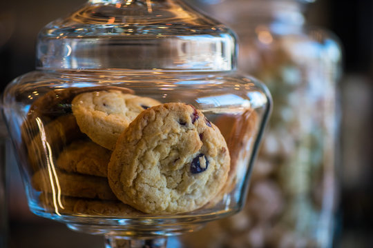 Oatmeal cookie in glass jar, closeup photo