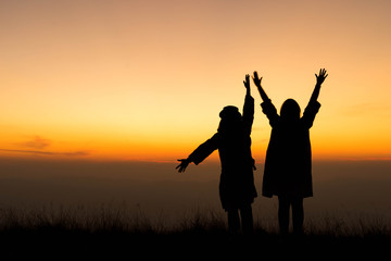 silhouette people friendship with sunset sky background