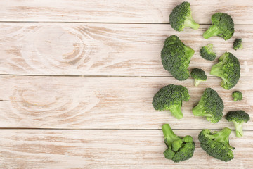Obraz na płótnie Canvas fresh broccoli on white wooden background with copy space for your text. Top view