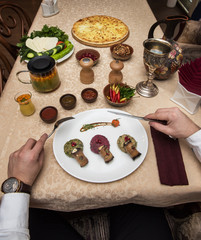 Man eating in georgian restaurant with national dishes, pov view