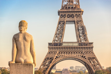 Woman stone statue in the Trocadero garden, Eiffel tower in the background, Paris France