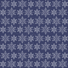 Vector seamless pattern. Christmas illustration of delicate snowflakes on a blue background.