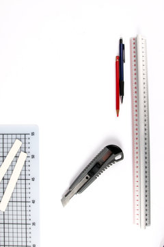 Graphic designer tools. Atelier equipment. Box cutter, cutting mat, pencil and ruler. Art Concept. Top view. Copy space.