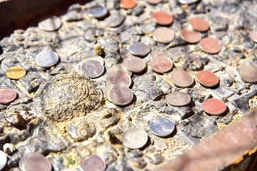 Thai Coins for Donation at a Buddhist Temple