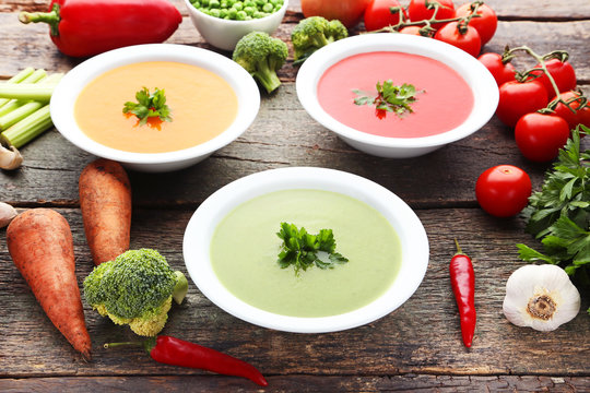 Vegetable cream soup with parsley on wooden table