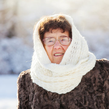 Old woman walking at winter park