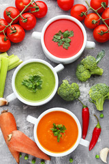 Vegetable cream soup with parsley on grey wooden table