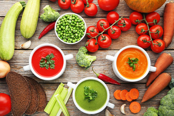 Vegetable cream soup with parsley on grey wooden table