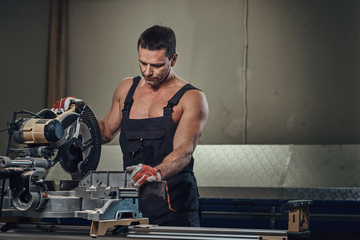 A man works with circular saw.